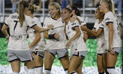 Gisele Thompson celebrates with her teammates after scoring for Angel City against the Washington Spirit.