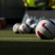 NWSL game balls sitting on the pitch in Kansas City. Photo is taken at ground level.